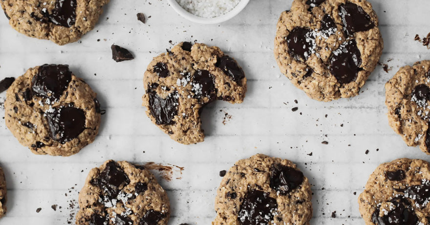 Chocolate chip cookies on table, one bitten