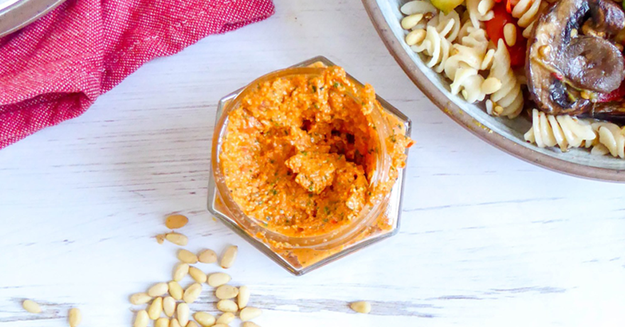 sundried tomato on table, next to bowl of pasta